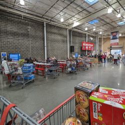 Costco Wholesale - Inside. Food court seating area, membership counter, and exit.
