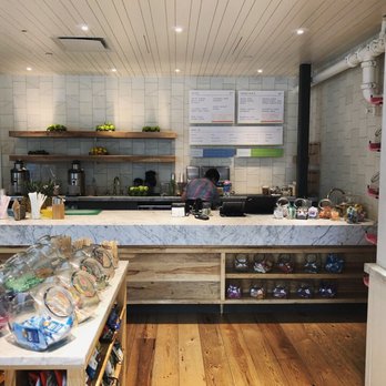 Jugo - a kitchen with a counter and shelves - Juice Bars & Smoothies Near Me - Austin, Texas