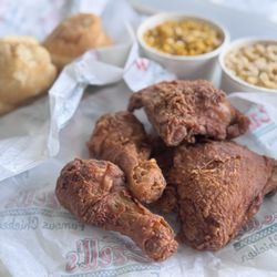 Ezell's Famous Chicken - 4 piece dark chicken, fresh bread rolls, mac & cheese, and kernel corns.
