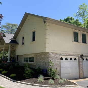 Alure Home Solutions - a car parked in front of a house - General Contractors Near Me - Commack, New York