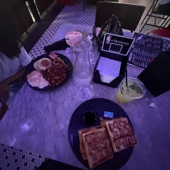 Wicked Wolf - Basic B Breakfast (left) with peach please and chicken and waffles (right) with Cuban mojito - Sports Bars Near Me - Atlanta, Georgia Wicked Wolf - Basic B Breakfast (left) with peach please and chicken and waffles (right) with Cuban mojito - Sports Bars Near Me - Atlanta, Georgia