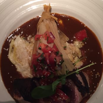 Rio Grill - Medium rare Duck breast with squash chilaquiles and duck confit tamale in a mole sauce. To die for. - American Near Me - Carmel-by-the-sea, California