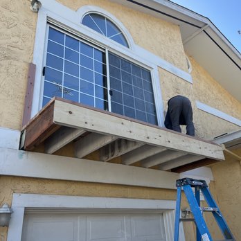 De Leon Remodeling - a man standing on a ladder - General Contractors Near Me De Leon Remodeling - a man standing on a ladder - General Contractors Near Me