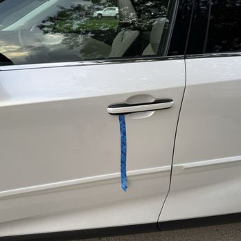Fields Lexus Glenview - Scratch left on the door after the repair, marked with blue tape. - Auto Repair Near Me - Glenview, Illinois Fields Lexus Glenview - Scratch left on the door after the repair, marked with blue tape. - Auto Repair Near Me - Glenview, Illinois