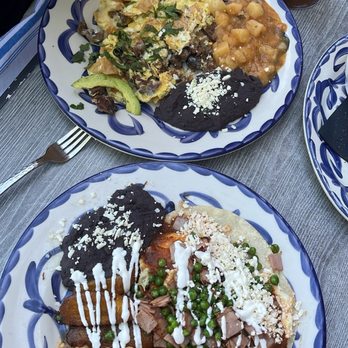 Ambriza - My plate the motuleño,(with the plantains) my husbands plate the chilaquiles with the steak. - Mexican Near Me - Houston, Texas