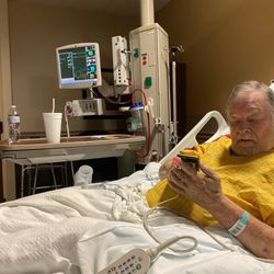 Texas Health Harris Methodist Hospital Southwest Fort Worth - Bobby dad looking at his phone while charging on 11/21/24 at 6.34 pm