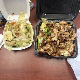 two take out containers of food on a table two take out containers of food on a table
