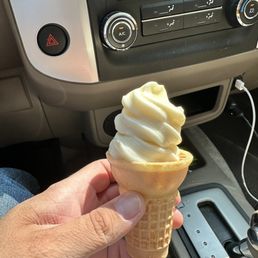 a hand holding an ice cream cone a hand holding an ice cream cone