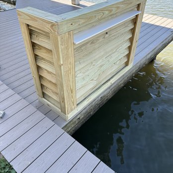 TCB Remodeling & Construction - a wooden dock with a boat on it - Electricians Near Me