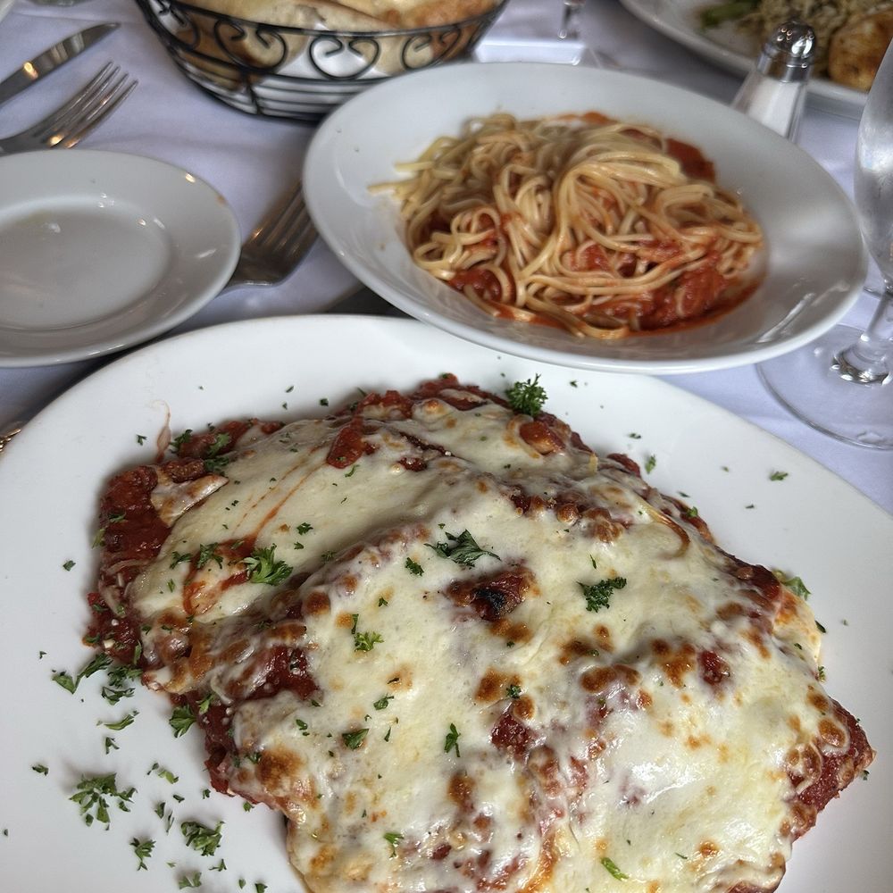 Ruvo - Eggplant Parm with a side of marinara sauce with linguini. Warm bread seasoned with rosemary - Italian Near Me - Port Jefferson, New York