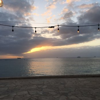 Barefoot Beach Cafe - Cute lights stretched across the picnic table eating area - Breakfast & Brunch Near Me - Honolulu, Hawaii