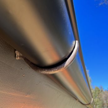 Elite Rain Gutters - Half-round, black rain gutters with cast holders cut to our slant close up of holder. - Gutter Services Near Me - Anaheim, California Elite Rain Gutters - Half-round, black rain gutters with cast holders cut to our slant close up of holder. - Gutter Services Near Me - Anaheim, California