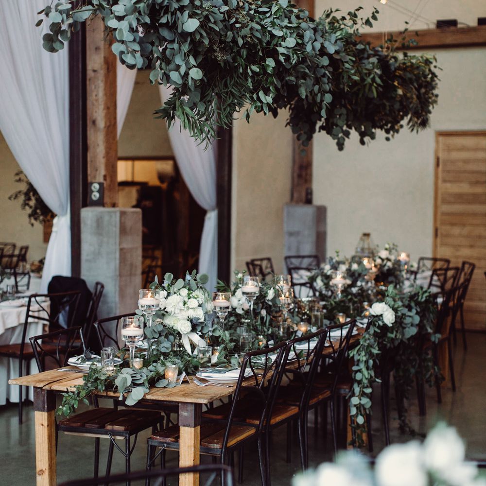 Exquisite Petals Floral Design - Reception head table decor (hanging greenery, greenery on table, candles, flowers, compotes) provided by Exquisite Petals - Party & Event Planning Near Me