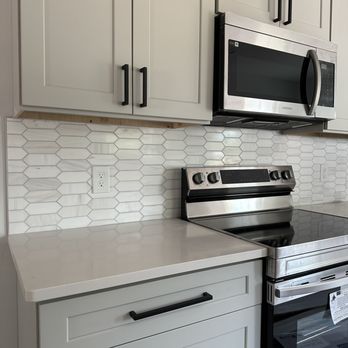 BWS Homes - Gorgeous new soft colored kitchen cabinets accented with black pulls, coordinating backsplash, and stainless steel appliances. - General Contractors Near Me BWS Homes - Gorgeous new soft colored kitchen cabinets accented with black pulls, coordinating backsplash, and stainless steel appliances. - General Contractors Near Me
