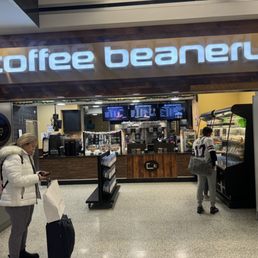 two people walking through a coffee beanery