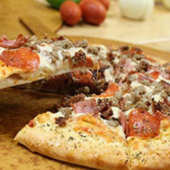 Dan's Pizza - a half eaten pizza on a cutting board - Pizza Near Me - Edmond, Oklahoma Dan's Pizza - a half eaten pizza on a cutting board - Pizza Near Me - Edmond, Oklahoma