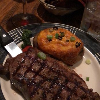 Cork 'n Cleaver - 14 oz ribeye and twice baked potato - Steakhouses Near Me - Evansville, Indiana