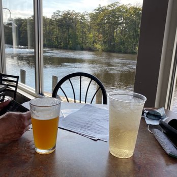 Dockside Pocomoke - a person sitting at a table with a glass of beer - American Near Me - Pocomoke City, Maryland