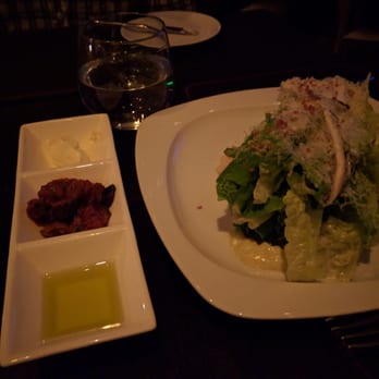 Scarpetta - Overdressed caesar salad next to the condiments for the bread basket. - Italian Near Me - Las Vegas, Nevada Scarpetta - Overdressed caesar salad next to the condiments for the bread basket. - Italian Near Me - Las Vegas, Nevada