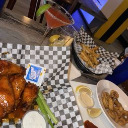 Calamari. Wings, fries, cosmopolitan