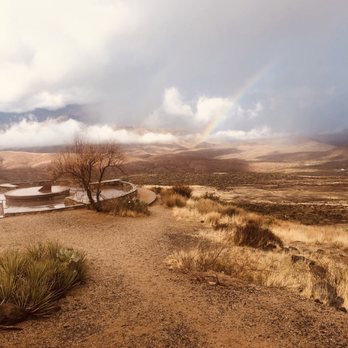 Sunset Point Rest Area - Walking path - A desert scene with dry grass, a tree, and a rainbow in a cloudy sky, taken at Sunset Point Rest Area in Congress, AZ. - Rest Stops Near Me - Congress, Arizona