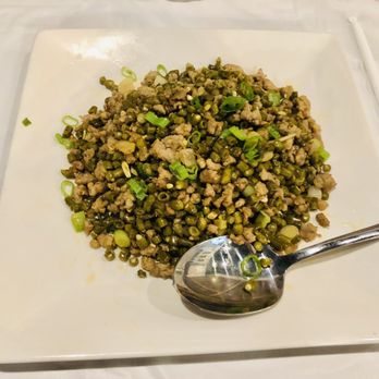 Seven Spice - a plate of food with a spoon - Chinese Near Me - Austin, Texas Seven Spice - a plate of food with a spoon - Chinese Near Me - Austin, Texas