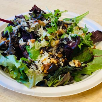 Paella House Snohomish - All organic Manchego Salad made with a mix of greens, oven-roasted walnuts and grated Manchego cheese, all dressed with EVOO! - Spanish Near Me - Snohomish, Washington