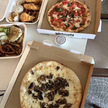 Monkeypod Kitchen - Each pizza is $25. Smaller than the box they provide. The margarita pizza has cold chopped tomatoes on it as it the pizza is a salad. - Hawaiian Near Me - Kapolei, Hawaii