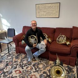 Houghton Horns - A customer trying out French horns in a private instrument trial room