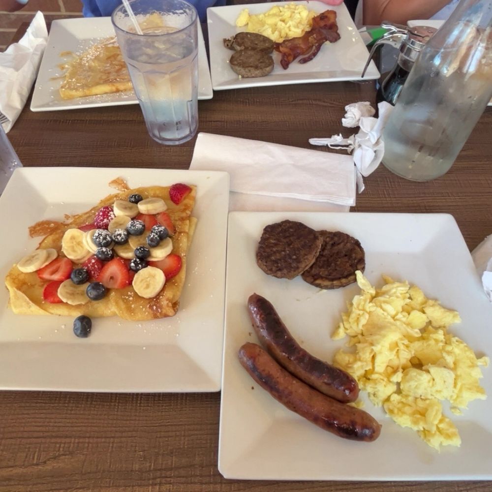 Crepe with blueberries strawberries and bananas with scrambled eggs and chicken sausage and turkey sausage Crepe with blueberries strawberries and bananas with scrambled eggs and chicken sausage and turkey sausage