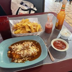 My meal, enchiladas, chips, and sour cream