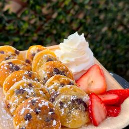 Chocolate chip, strawberry and whip cream pancakes.