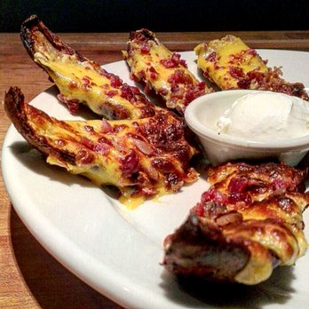 Cheddar's Scratch Kitchen - baked potatoes skin with cheese and bacon with sour cream for appetizer. $8+ - Comfort Food Near Me - Tucson, Arizona