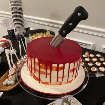 Sin - a cake with a knife sticking out of it - Desserts Near Me