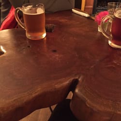 The Brigand - Old wooden table tops (and the captain cooker Manuka beer and tuatara beer)
