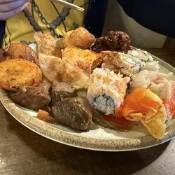 Magnolia Buffet - Sushi, fried plantain, a variety of foods.