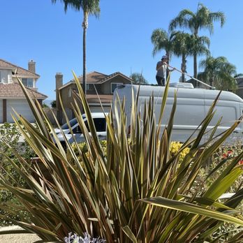 Deluxe Mobile Detailing - Nico cleaning the top of the roof with solar panels - Auto Detailing Near Me