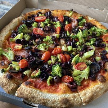 UNA Pizza + Wine - Banff - Close-up of their delicious vegan pizza - Italian Near Me - Banff, Alberta UNA Pizza + Wine - Banff - Close-up of their delicious vegan pizza - Italian Near Me - Banff, Alberta