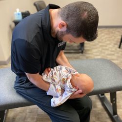 Curis Functional Health - Rockwall - Dr. Waters making an adjustment to a brand new baby!