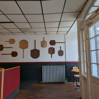 Ollie's Pizza - a row of paddles on the wall - Pizza Near Me - Litchfield, Connecticut