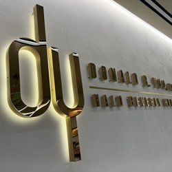 Custom Building Signage - Halo illuminated logo with gold titanium finish
