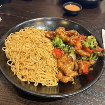 P.F. Chang's - Sesame chicken bowl with lo mein. In the back is Crispy Honey Chicken Bowl with an egg roll. - Chinese Near Me - Birmingham, Alabama