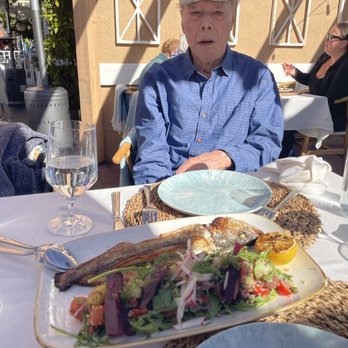 Elia - My dad who was a foodie staring at his whole sea bass with happy thought... - Greek Near Me - Pleasanton, California