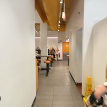 Egg Tuck - a woman walking down a hallway - Coffee & Tea Near Me - Chicago, Illinois