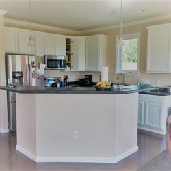 High Performance Modular Homes - White kitchen cabinets and raised bar top island