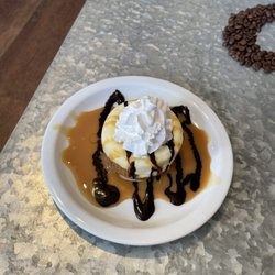 Uptown Coffee Café - Mini New York style cheesecake topped with caramel and chocolate sauce and whipped topping.