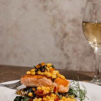 Riverside Revival - a plate of salmon, corn, and a glass of wine - Venues & Event Spaces Near Me - Nashville, Tennessee