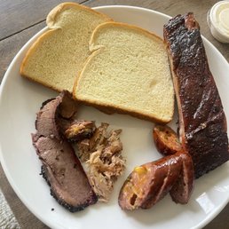 Sliced brisket, pulled chicken, jalapeño cheddar sausage, sparerib and bread. Sliced brisket, pulled chicken, jalapeño cheddar sausage, sparerib and bread.