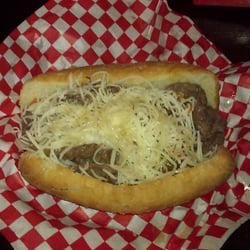 D'em Dogz "Chicago Style" - Slowly Roasted & thinly sliced Italian Beef on a French bread roll with Au Jus, Giardiniera spices & Mozzarella cheese!