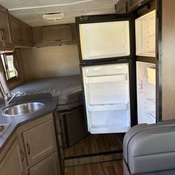 Refrigerator/freezer. These automatically operate via propane when camping and battery when RV engine or generator is running.